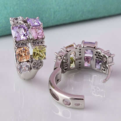 These elegant huggie earrings feature medium-sized silver pink and purple stones. Made from hypoallergenic, tarnish-proof, and sustainable stainless steel, they are low maintenance and lightweight for comfortable all-day wear.