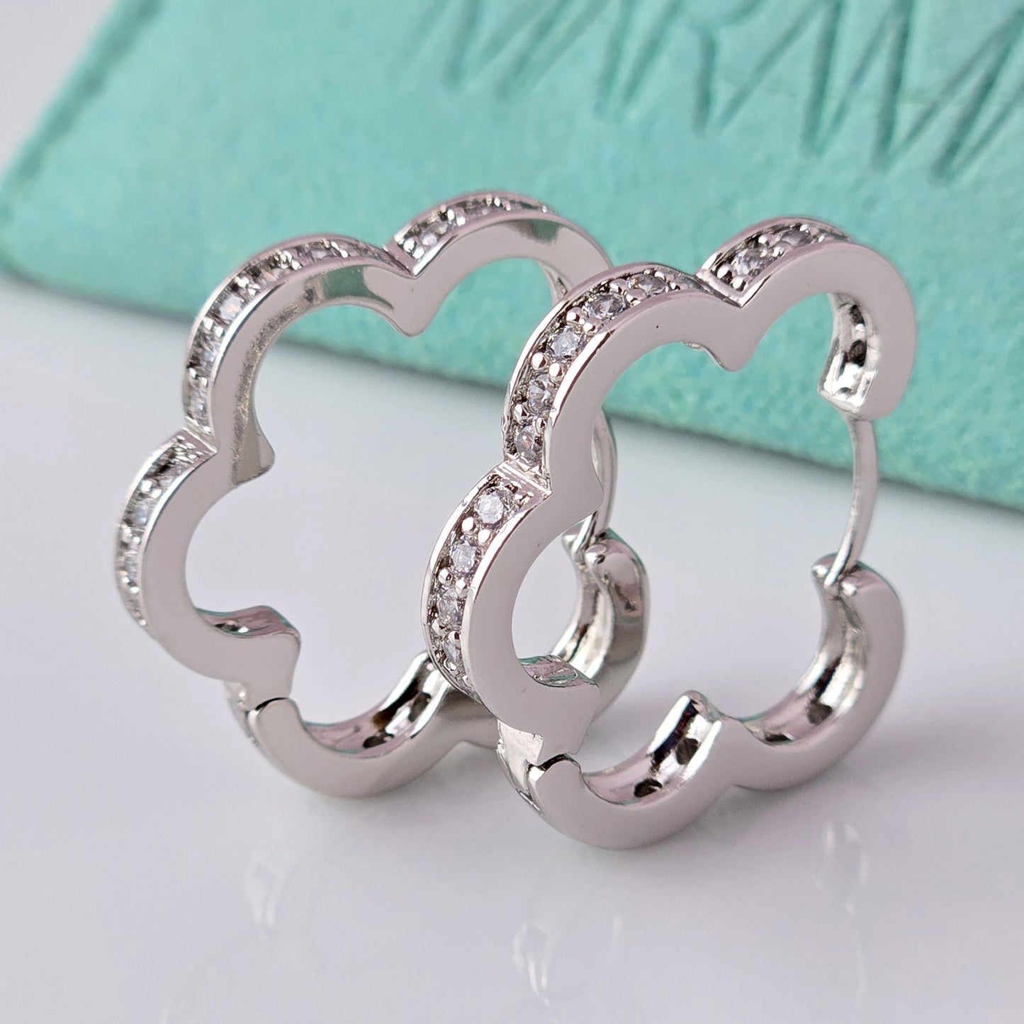 Crafted with precision and expertise, our Medium Silver Sparkle Daisy Hoop Earrings are the epitome of quality. Made from hypoallergenic stainless steel, these earrings are tarnish-proof and sustainable, providing a low maintenance, lightweight option for everyday wear. Elevate any outfit with a touch of elegance and durability.