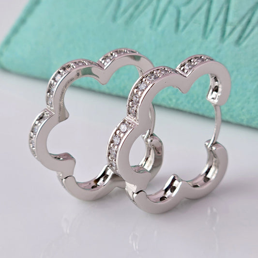 Crafted with precision and expertise, our Medium Silver Sparkle Daisy Hoop Earrings are the epitome of quality. Made from hypoallergenic stainless steel, these earrings are tarnish-proof and sustainable, providing a low maintenance, lightweight option for everyday wear. Elevate any outfit with a touch of elegance and durability.