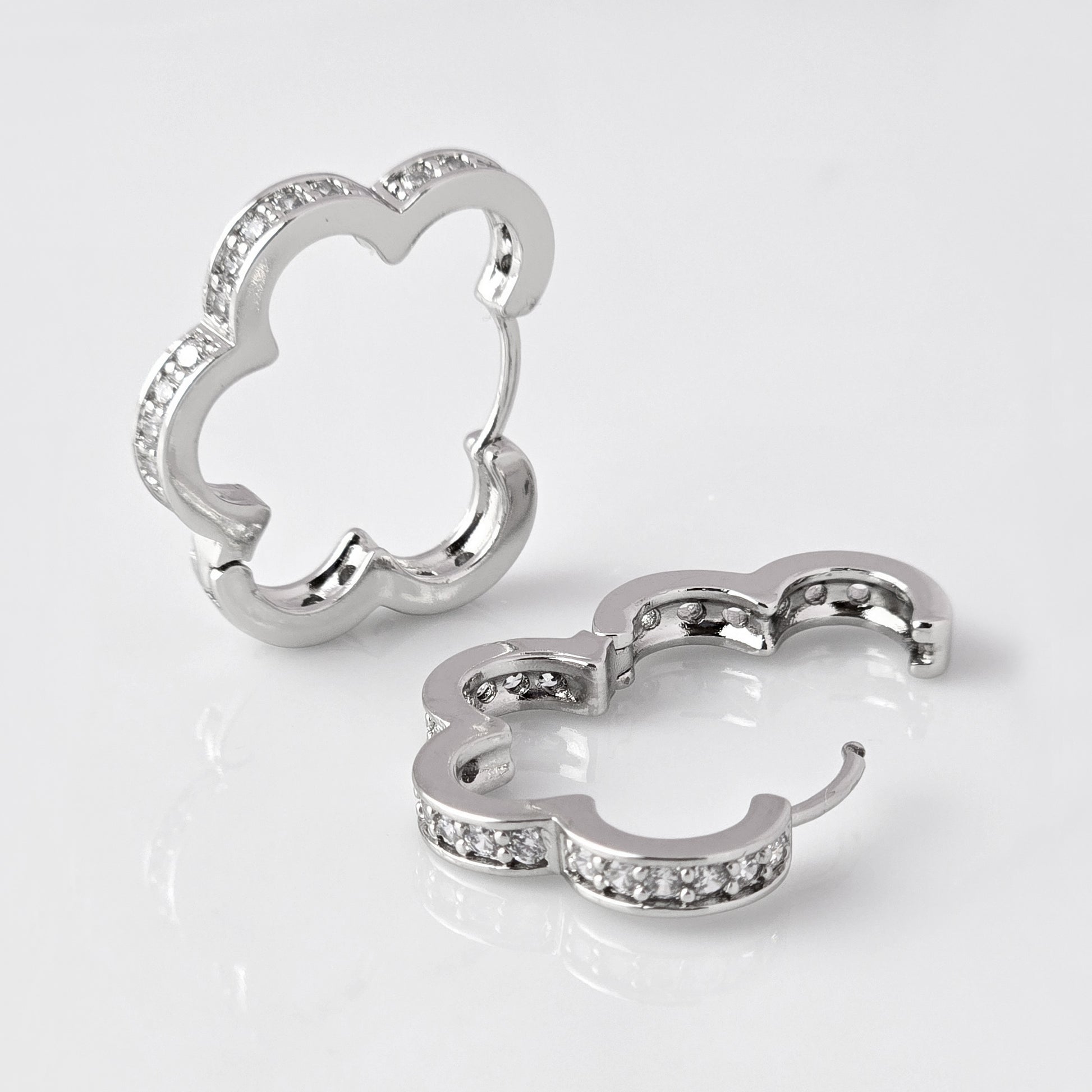 Crafted with precision and expertise, our Medium Silver Sparkle Daisy Hoop Earrings are the epitome of quality. Made from hypoallergenic stainless steel, these earrings are tarnish-proof and sustainable, providing a low maintenance, lightweight option for everyday wear. Elevate any outfit with a touch of elegance and durability.