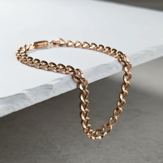 Rose gold chain bracelet on a marble surface