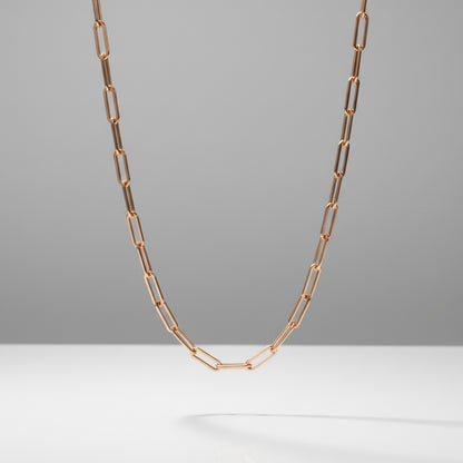 Rose gold chain necklace on a gray background