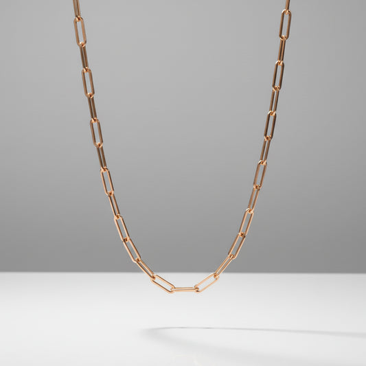 Rose gold chain necklace on a gray background