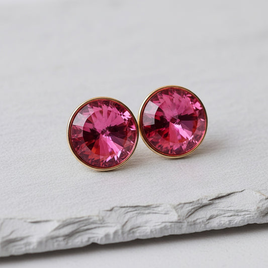 Pink gemstone earrings on a light gray surface
