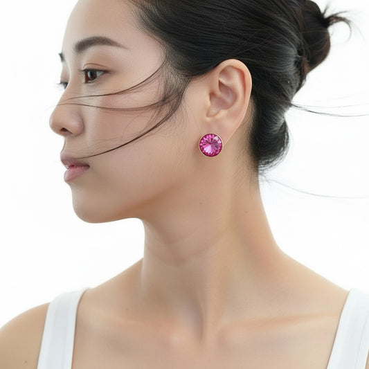 Close-up of a woman wearing pink earrings with a plain background