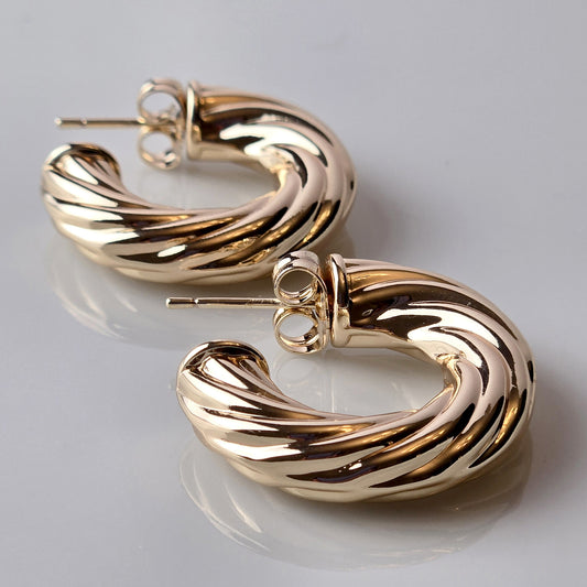 These Rose Gold Twisted Hoop Earrings are expertly crafted using hypoallergenic, water-resistant, and sweat-resistant stainless steel, ensuring a durable and sustainable product. With a tarnish-proof finish, they require low maintenance and are lightweight for comfortable wear. Elevate your style with these high-quality earrings.