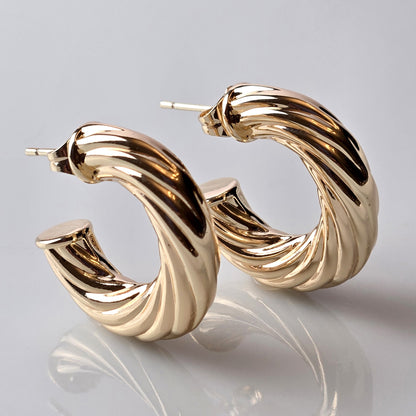 These Rose Gold Twisted Hoop Earrings are expertly crafted using hypoallergenic, water-resistant, and sweat-resistant stainless steel, ensuring a durable and sustainable product. With a tarnish-proof finish, they require low maintenance and are lightweight for comfortable wear. Elevate your style with these high-quality earrings.