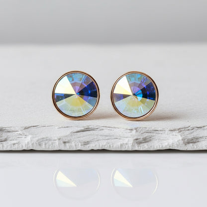 Round earrings with multicolored gemstones on a white surface