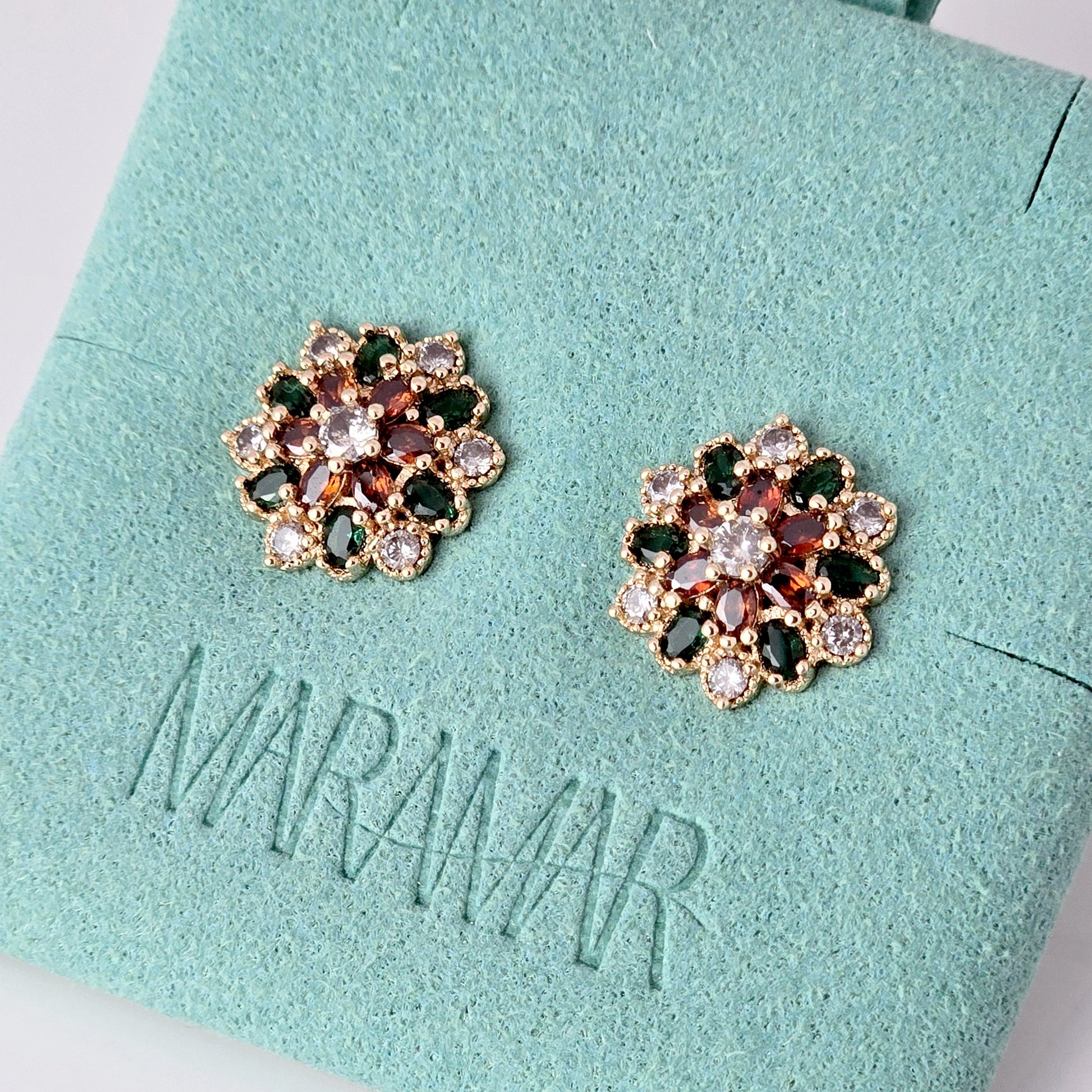 Each earring in this set of Small Rose Gold Green Red Flower Stud Earrings is made with hypoallergenic, high-quality stainless steel that is tarnish-proof and sustainable. Enjoy the benefit of low maintenance and lightweight earrings that will add a touch of color and elegance to any outfit.