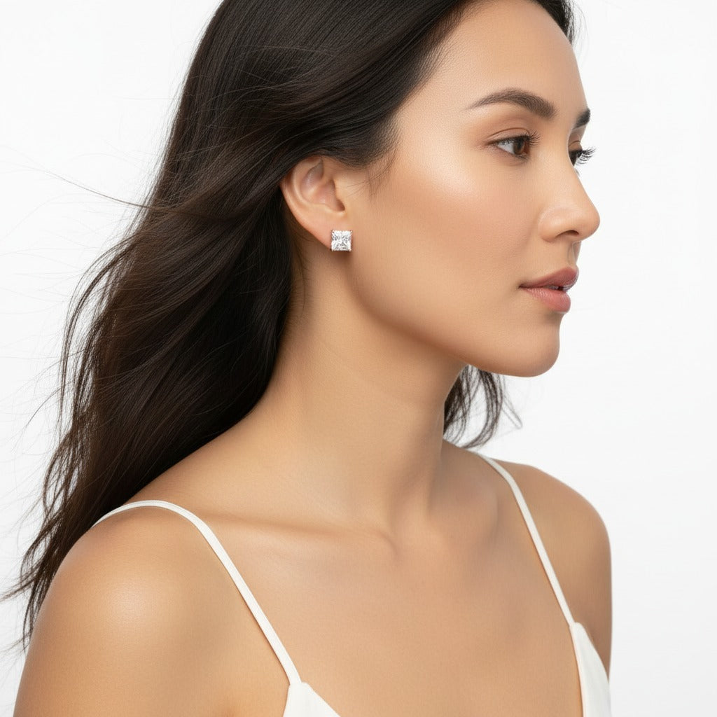 Woman wearing diamond earrings on a white background