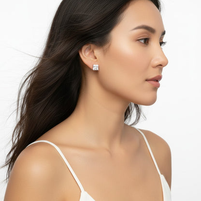 Woman wearing diamond earrings on a white background