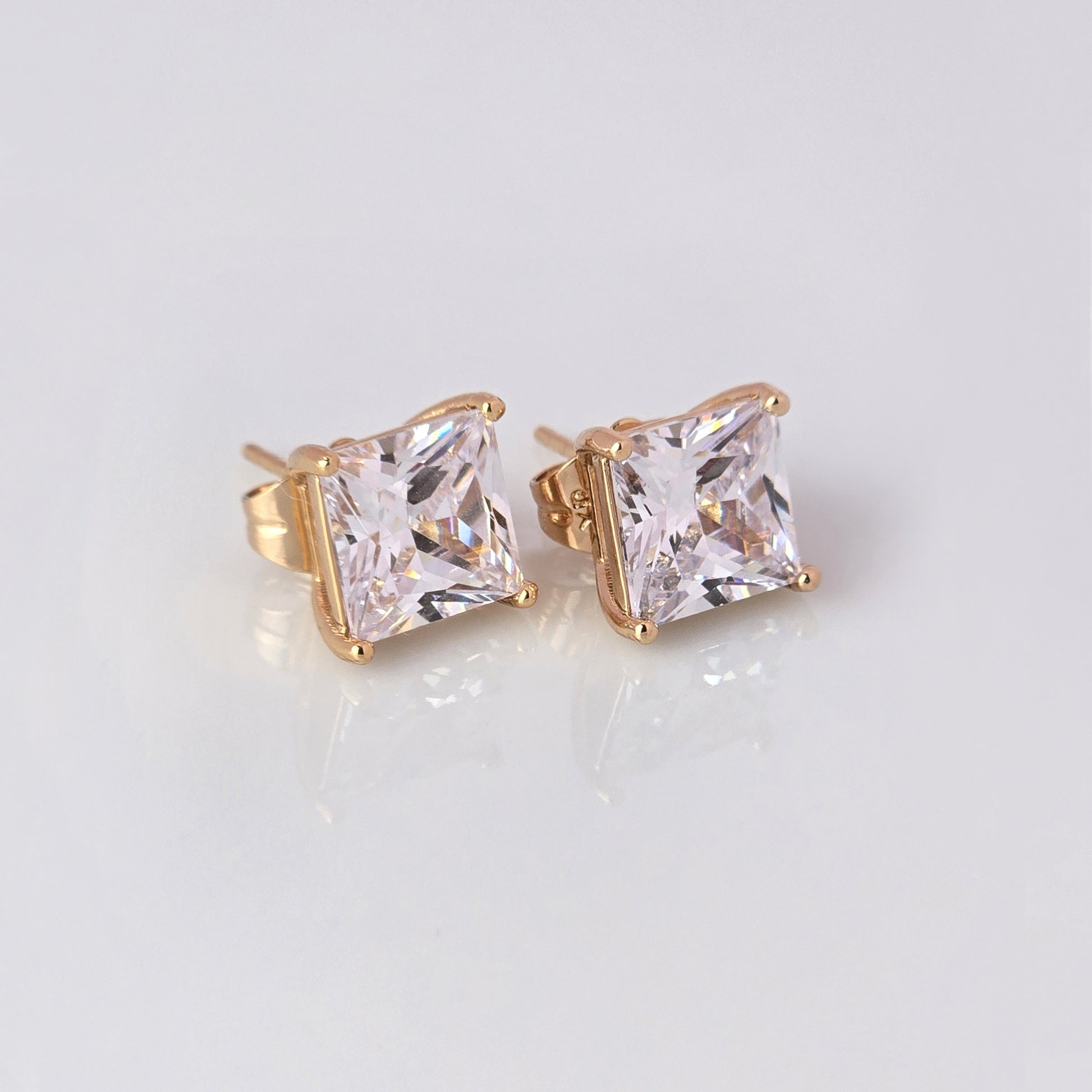 
Upgrade your jewelry collection with our Small Rose Gold Princess Cut Stud Earrings. Crafted from hypoallergenic, tarnish-proof stainless steel, these earrings are both sustainable and low maintenance. Enjoy the lightweight design and timeless beauty of this high-quality piece.