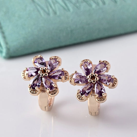 Crafted with the highest quality hypoallergenic stainless steel, these Small Rose Gold Purple Flower Huggie Earrings are both sustainable and lightweight. With a tarnish-proof design and low maintenance requirements, these earrings are a durable and stylish addition to any accessory collection.