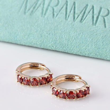Elevate your style with our Small Rose Gold Red Garnet Huggie Earrings. Made from high-quality hypoallergenic stainless steel, these earrings are sustainable, tarnish-proof, and low maintenance while still remaining lightweight. The small size and elegant cut of the red garnet make for a perfect everyday accessory that adds a touch of sophistication to any outfit.