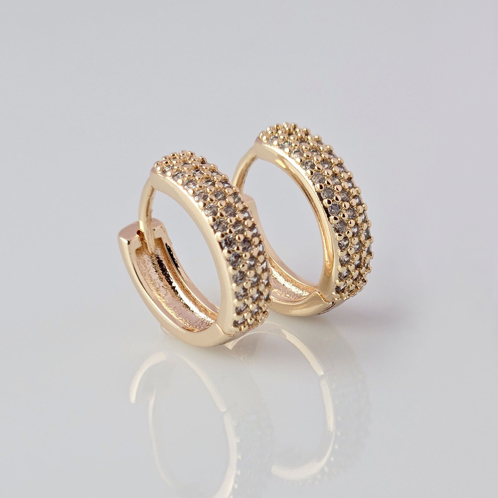 Expertly crafted from hypoallergenic, tarnish-proof stainless steel, these Small Rose Gold Sparkle Huggie Earrings offer both style and sustainability. With low maintenance and a lightweight design, they are perfect for everyday wear. Elevate your look with these high-quality, durable earrings.