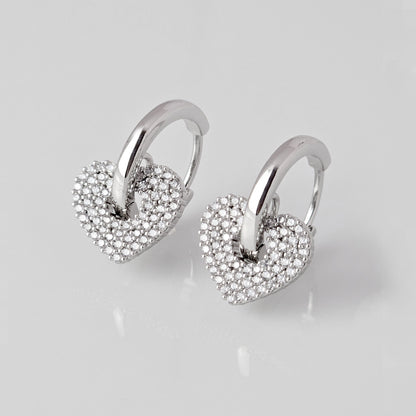 Crafted from low maintenance and hypoallergenic stainless steel, these Small Silver Sparkle Hearts Hoop Earrings boast a tarnish-proof design that is both sustainable and lightweight. Enjoy high-quality, luxurious style without any worries of skin irritation.