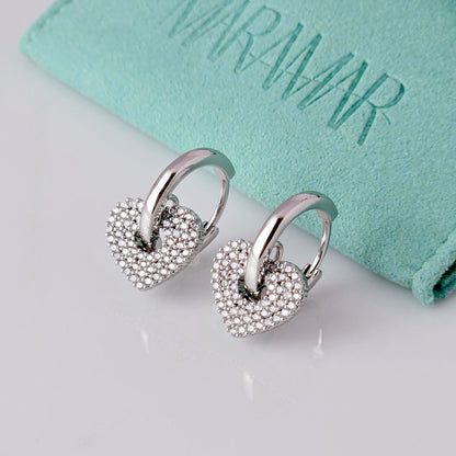 Crafted from low maintenance and hypoallergenic stainless steel, these Small Silver Sparkle Hearts Hoop Earrings boast a tarnish-proof design that is both sustainable and lightweight. Enjoy high-quality, luxurious style without any worries of skin irritation.