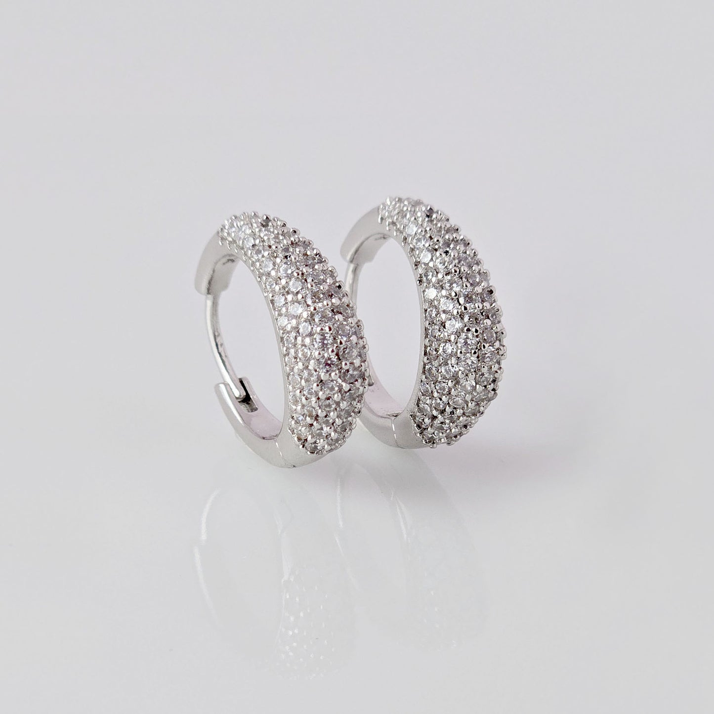 As a product expert, I can confidently assert that these Small Silver Sparkle Huggie Earrings are made of hypoallergenic, tarnish-proof, and sustainable stainless steel. With low maintenance and lightweight design, these earrings are both practical and stylish. Elevate any outfit with the highest quality earrings that offer both comfort and durability.