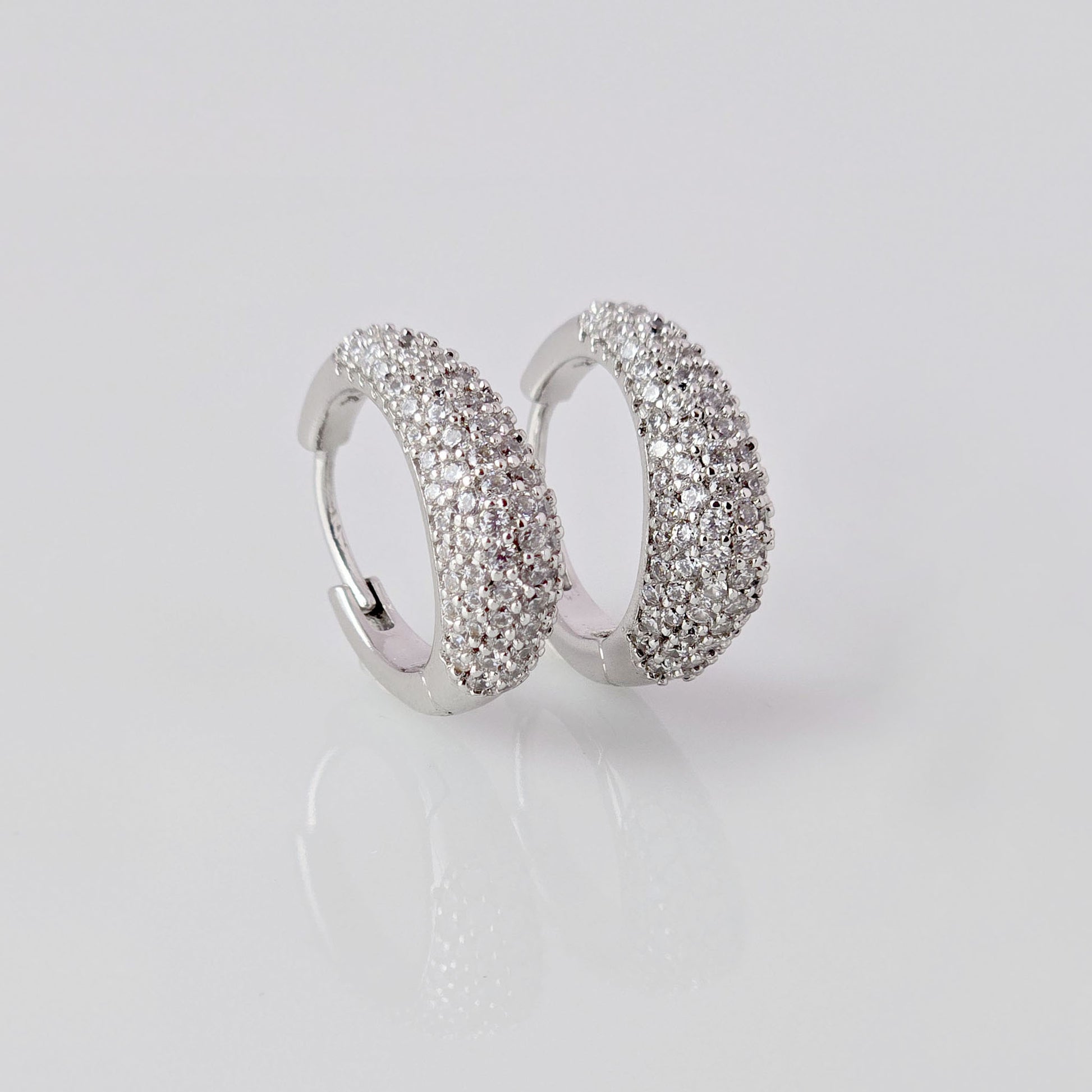As a product expert, I can confidently assert that these Small Silver Sparkle Huggie Earrings are made of hypoallergenic, tarnish-proof, and sustainable stainless steel. With low maintenance and lightweight design, these earrings are both practical and stylish. Elevate any outfit with the highest quality earrings that offer both comfort and durability.