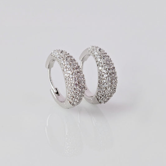 As a product expert, I can confidently assert that these Small Silver Sparkle Huggie Earrings are made of hypoallergenic, tarnish-proof, and sustainable stainless steel. With low maintenance and lightweight design, these earrings are both practical and stylish. Elevate any outfit with the highest quality earrings that offer both comfort and durability.