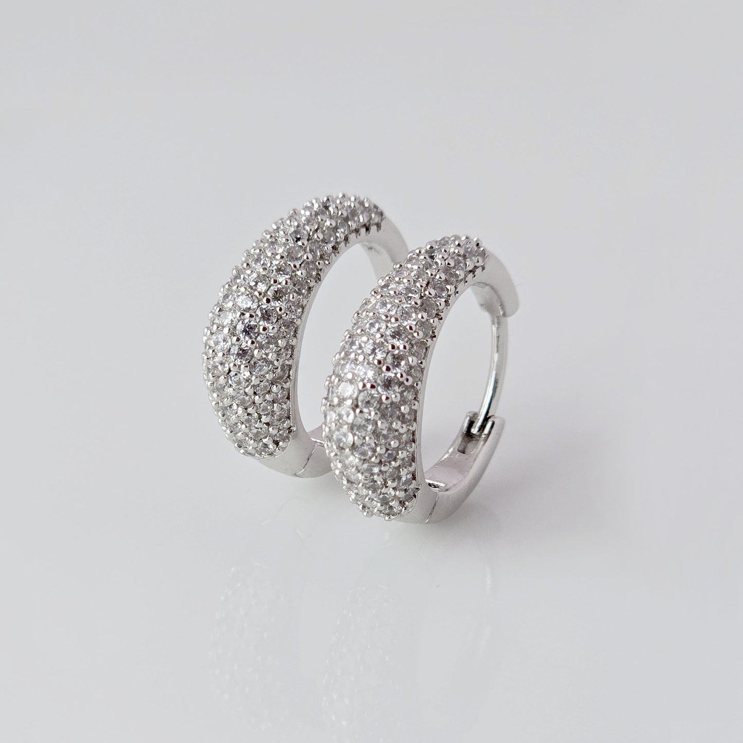 As a product expert, I can confidently assert that these Small Silver Sparkle Huggie Earrings are made of hypoallergenic, tarnish-proof, and sustainable stainless steel. With low maintenance and lightweight design, these earrings are both practical and stylish. Elevate any outfit with the highest quality earrings that offer both comfort and durability.