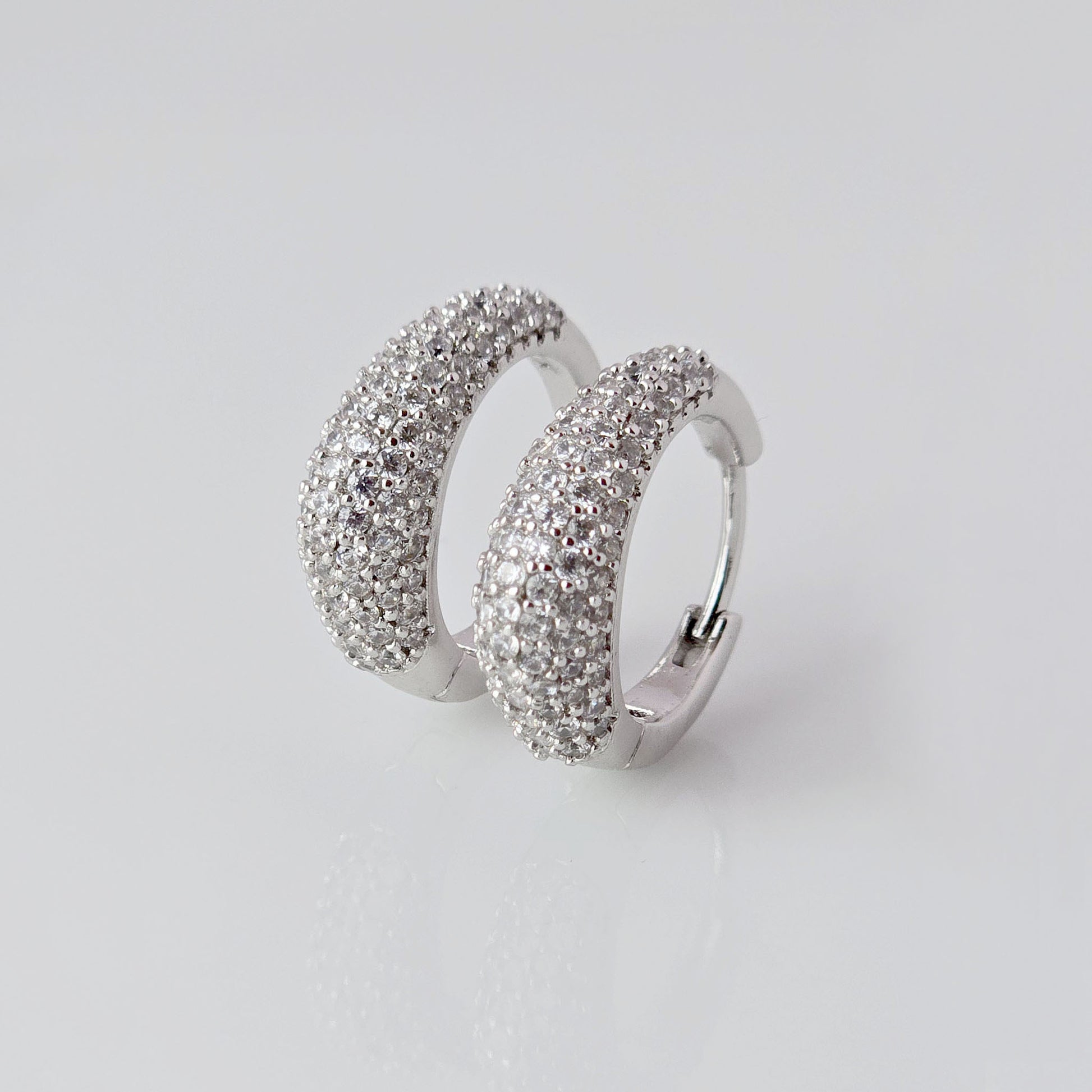 As a product expert, I can confidently assert that these Small Silver Sparkle Huggie Earrings are made of hypoallergenic, tarnish-proof, and sustainable stainless steel. With low maintenance and lightweight design, these earrings are both practical and stylish. Elevate any outfit with the highest quality earrings that offer both comfort and durability.