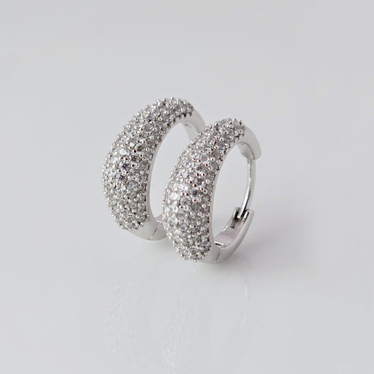 As a product expert, I can confidently assert that these Small Silver Sparkle Huggie Earrings are made of hypoallergenic, tarnish-proof, and sustainable stainless steel. With low maintenance and lightweight design, these earrings are both practical and stylish. Elevate any outfit with the highest quality earrings that offer both comfort and durability.