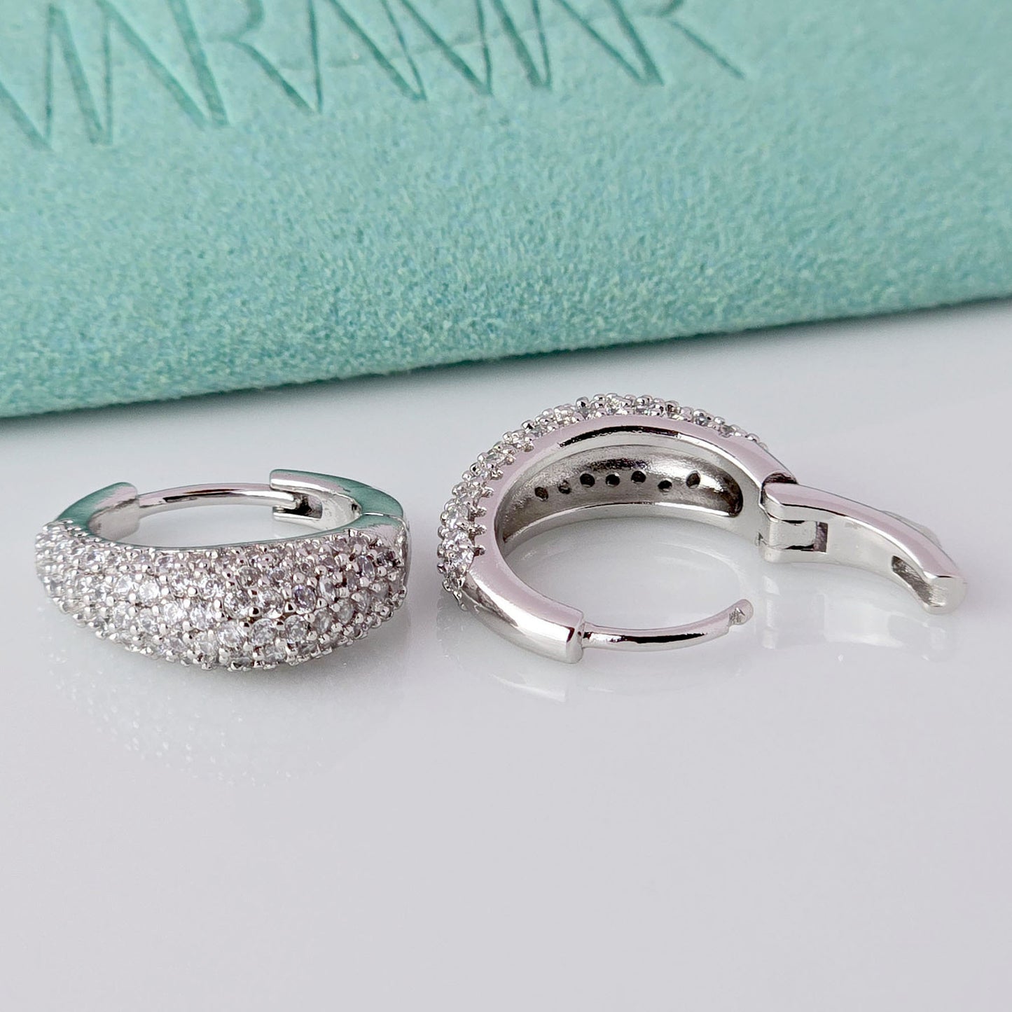 As a product expert, I can confidently assert that these Small Silver Sparkle Huggie Earrings are made of hypoallergenic, tarnish-proof, and sustainable stainless steel. With low maintenance and lightweight design, these earrings are both practical and stylish. Elevate any outfit with the highest quality earrings that offer both comfort and durability.