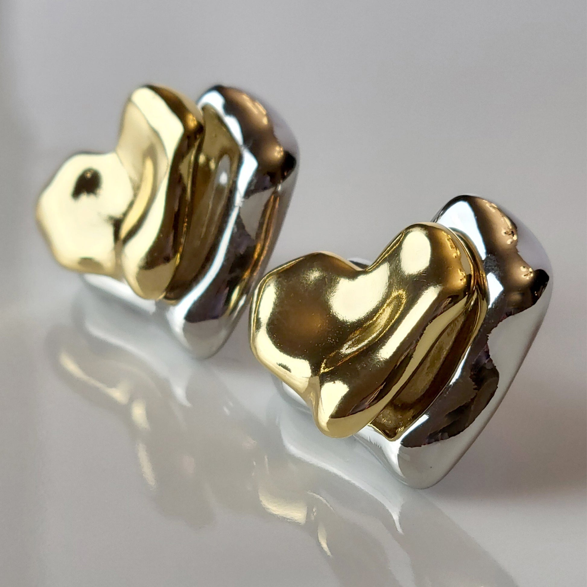These Two-Tone Double Heart Stud Earrings are expertly crafted with hypoallergenic and sustainable stainless steel for a lightweight and low maintenance wear. With a tarnish-proof design, these earrings will retain their high-quality appearance for years to come. A perfect addition to any jewelry collection.