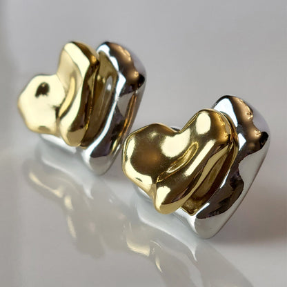 These Two-Tone Double Heart Stud Earrings are expertly crafted with hypoallergenic and sustainable stainless steel for a lightweight and low maintenance wear. With a tarnish-proof design, these earrings will retain their high-quality appearance for years to come. A perfect addition to any jewelry collection.
