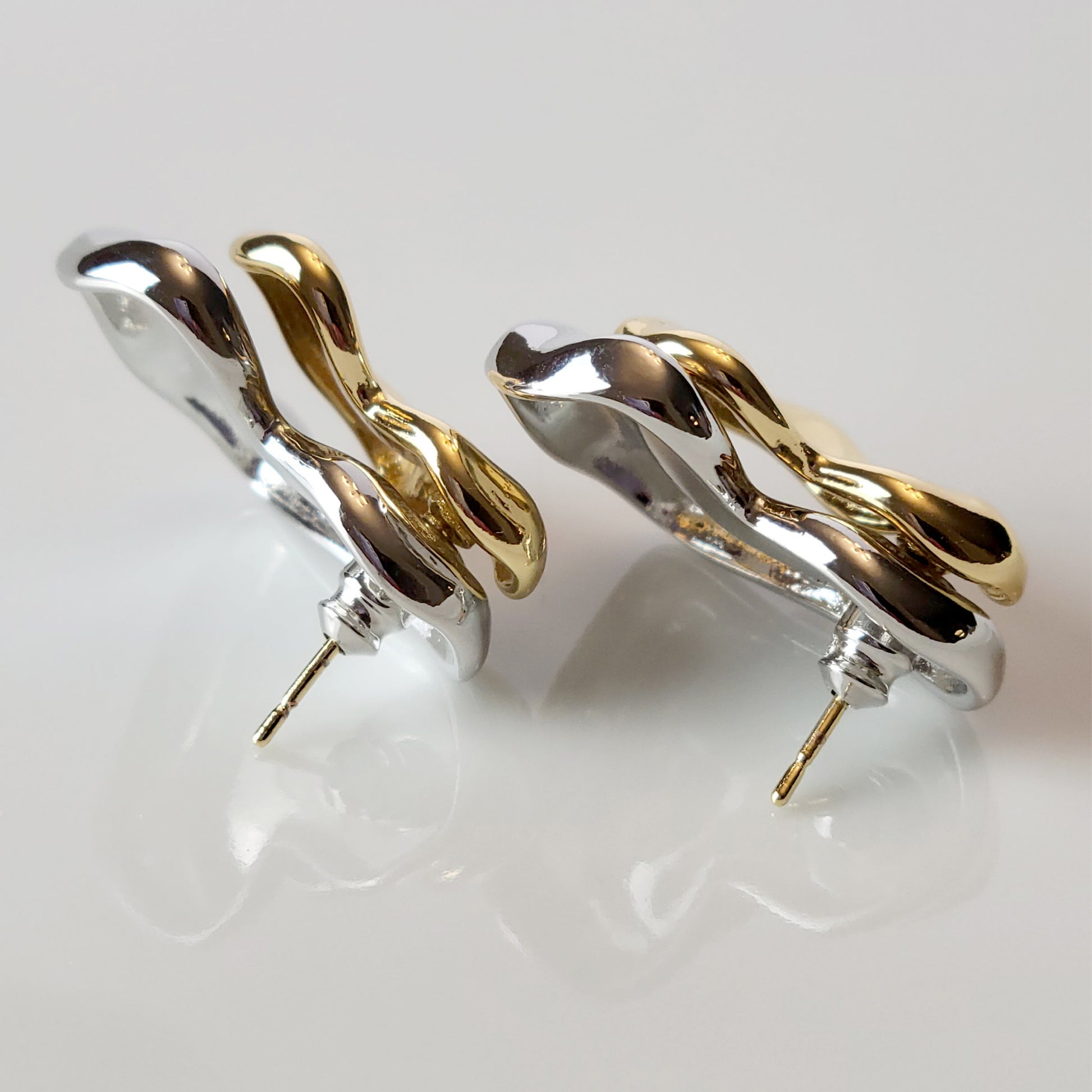 These Two-Tone Double Heart Stud Earrings are expertly crafted with hypoallergenic and sustainable stainless steel for a lightweight and low maintenance wear. With a tarnish-proof design, these earrings will retain their high-quality appearance for years to come. A perfect addition to any jewelry collection.