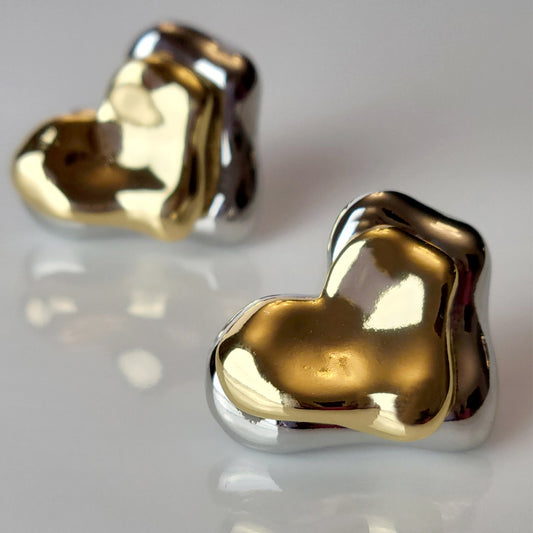 These Two-Tone Double Heart Stud Earrings are expertly crafted with hypoallergenic and sustainable stainless steel for a lightweight and low maintenance wear. With a tarnish-proof design, these earrings will retain their high-quality appearance for years to come. A perfect addition to any jewelry collection.