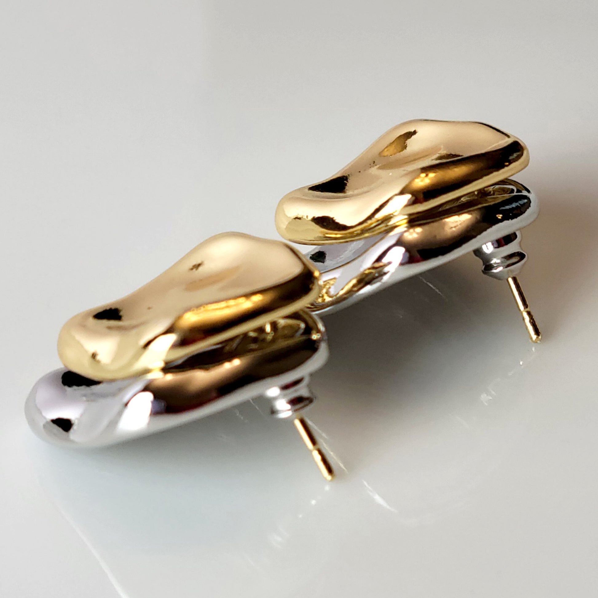 Crafted from premium stainless steel, these Two-Tone Double Square Stud Earrings offer the perfect blend of quality and style. Hypoallergenic and tarnish-proof, they require low maintenance and are lightweight for all-day comfort. Elevate any look with these sustainable earrings.