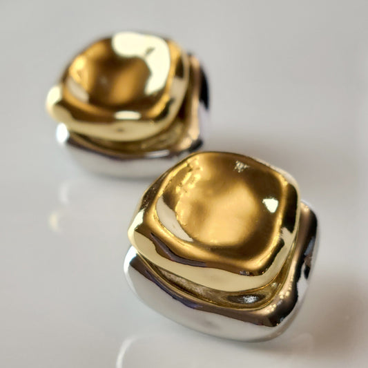 Crafted from premium stainless steel, these Two-Tone Double Square Stud Earrings offer the perfect blend of quality and style. Hypoallergenic and tarnish-proof, they require low maintenance and are lightweight for all-day comfort. Elevate any look with these sustainable earrings.