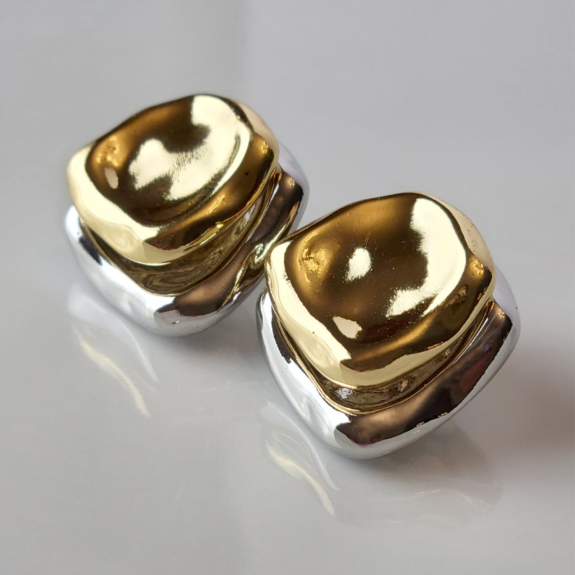 Crafted from premium stainless steel, these Two-Tone Double Square Stud Earrings offer the perfect blend of quality and style. Hypoallergenic and tarnish-proof, they require low maintenance and are lightweight for all-day comfort. Elevate any look with these sustainable earrings.