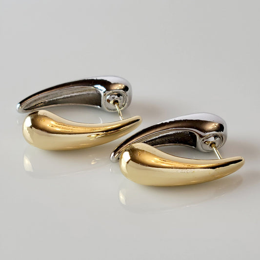 Expertly crafted from hypoallergenic, tarnish-proof stainless steel, these Two-Tone Tear Drop Dangle Earrings are both sustainable and low maintenance. The lightweight design makes them comfortable for all-day wear. Elevate any outfit with these high-quality, expertly-crafted earrings.